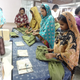 Workers cleaning up loose threads from a finished garment. Photo by Sarah Labowitz.